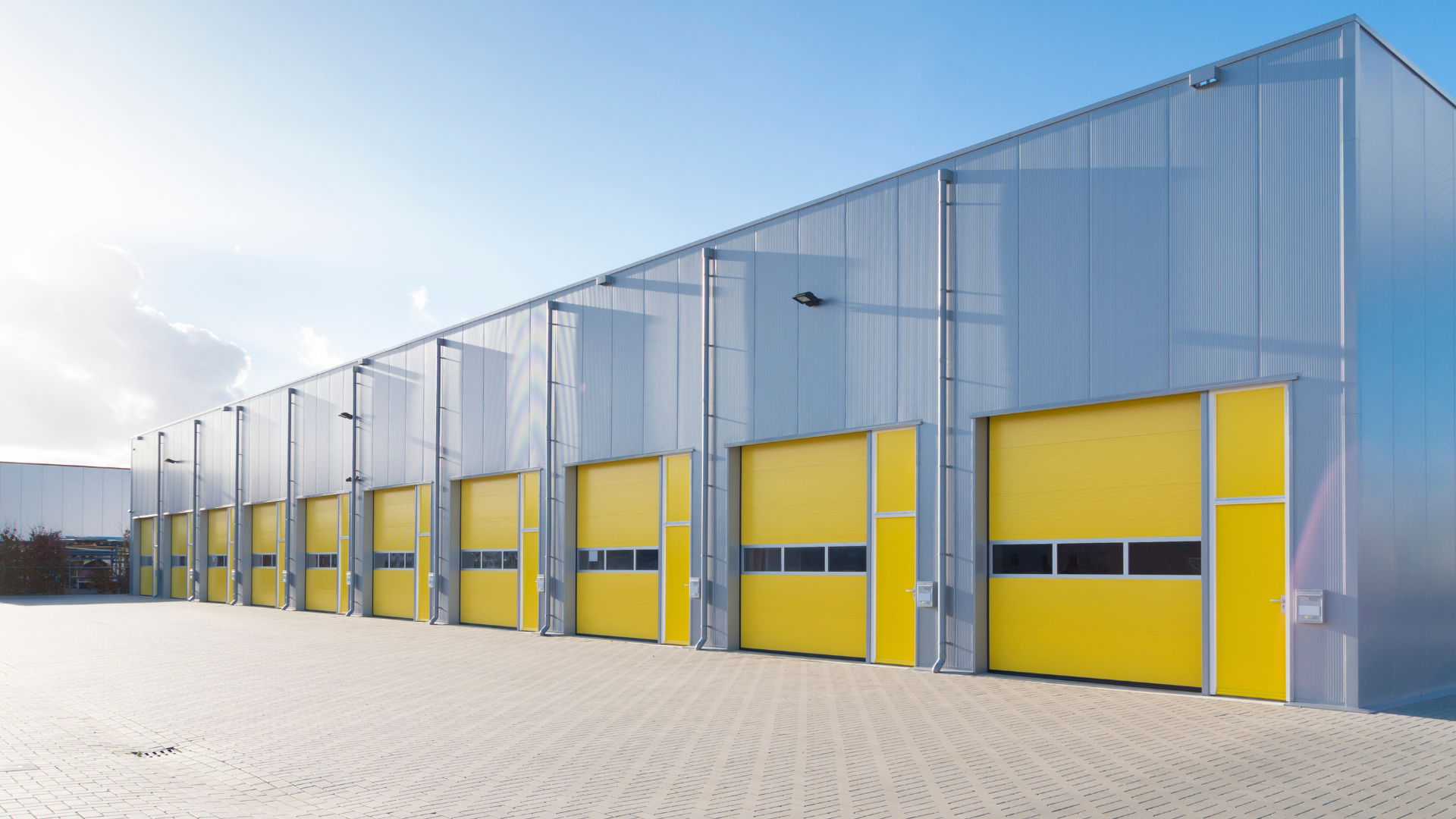 Exterior of a multi-site distribution center facility with a row of loading dock doors