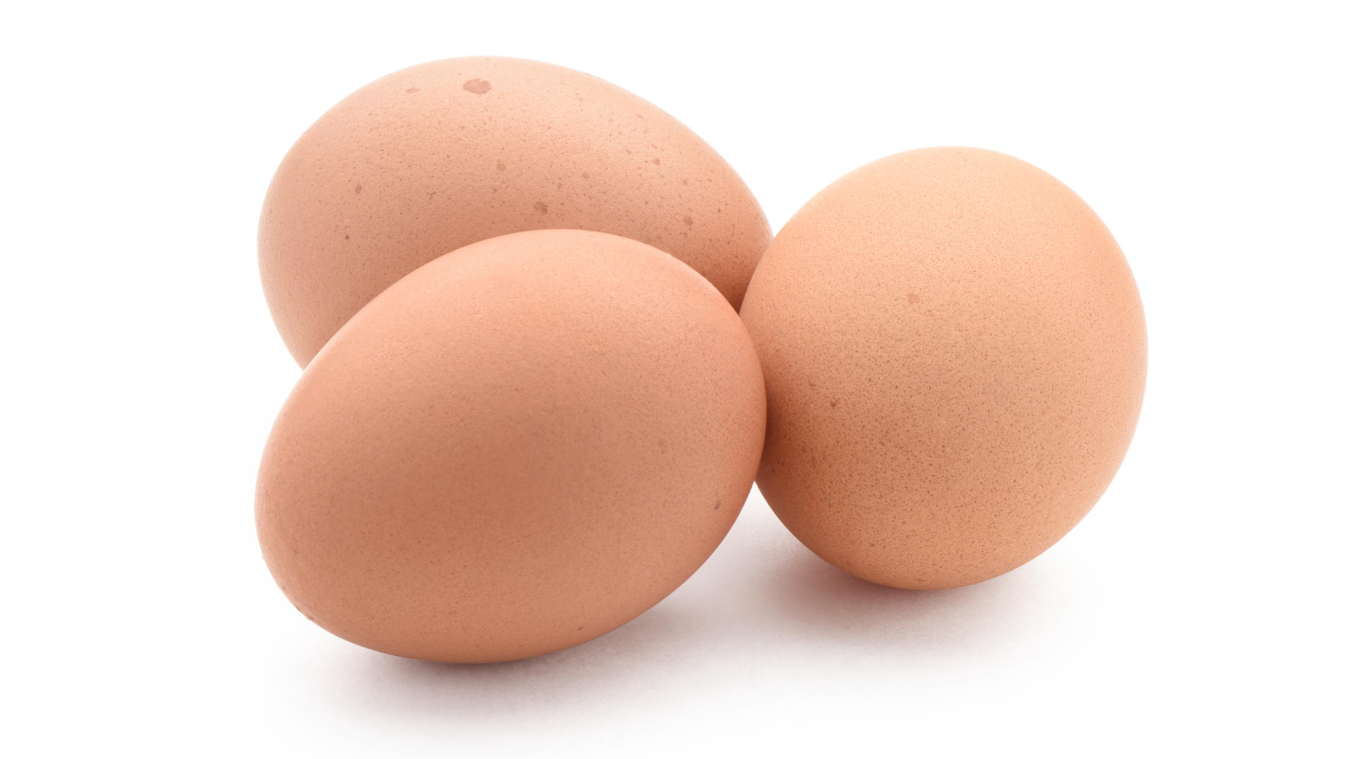 Three brown eggs on a white background, representing the 2026 Salmonella egg recall.