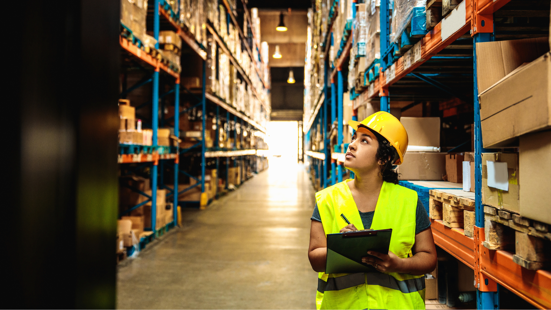 Warehouse worker checking inventory shelves, reflecting untracked indirect labor